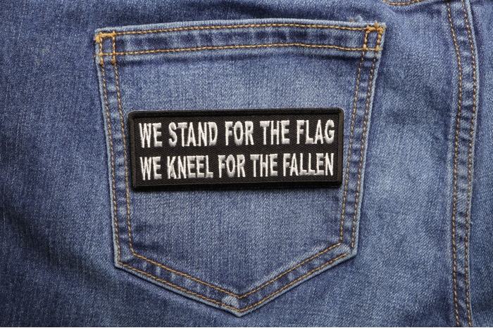 We Stand for the Flag We Kneel for the Fallen Patch shown on jeans