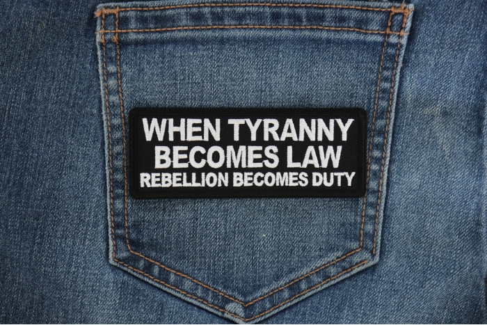 When Tyranny Becomes Law Rebellion Becomes Duty Patch shown on jeans