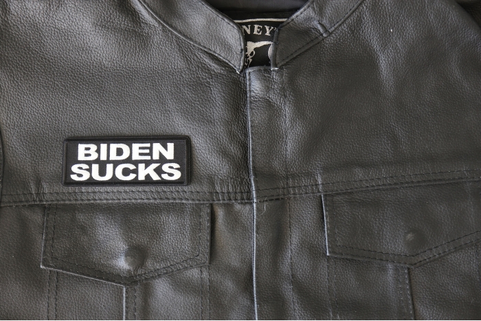 Biden Sucks Patch - 4x1.5 inch - Embroidered Iron on Patch shown on leather vest