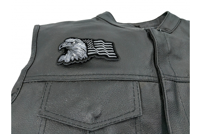 Eagle With Waving Flag Black Silver Patch - 4x2.5 inch. Embroidered Iron on Patch shown on leather vest