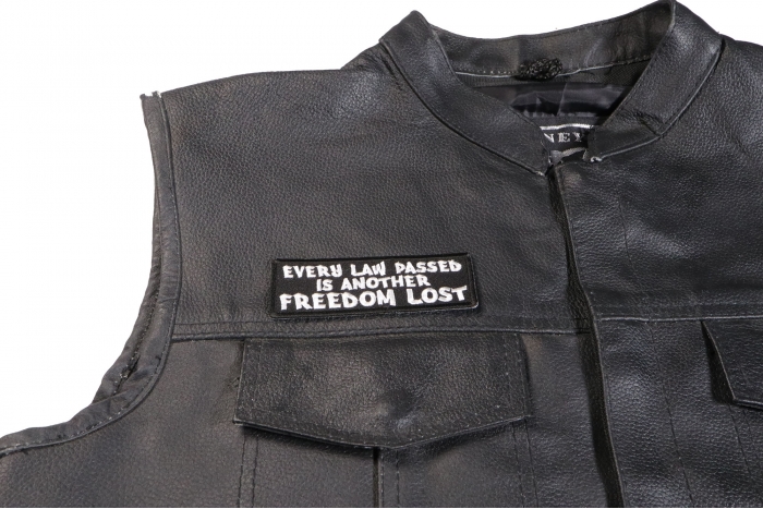Every Law Passed is Another Freedom Lost Patch - by Ivamis Trading - 4x1.5 inch - Embroidered Iron on Patch shown on leather vest