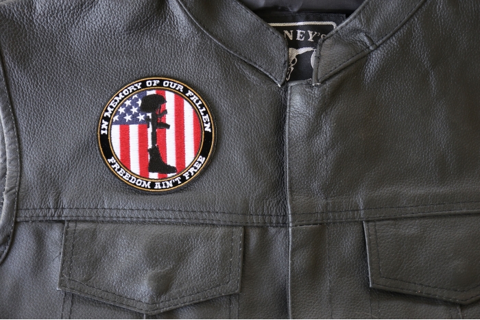 Freedom Ain't Free in Memory of Our Fallen Boot Rifle Helmet Patch - 3.5x3.5 inch. Embroidered Iron on Patch shown on leather vest