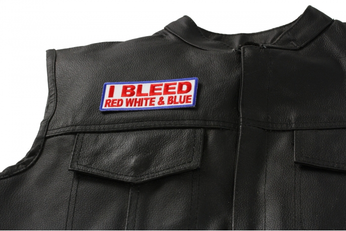 I Bleed Red White and Blue Patch - 4x1.5 inch. Embroidered Iron on Patch shown on leather vest