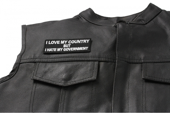 I Love My Country Hate My Government Patch - 4x1.5 inch. Embroidered Iron on Patch shown on leather vest