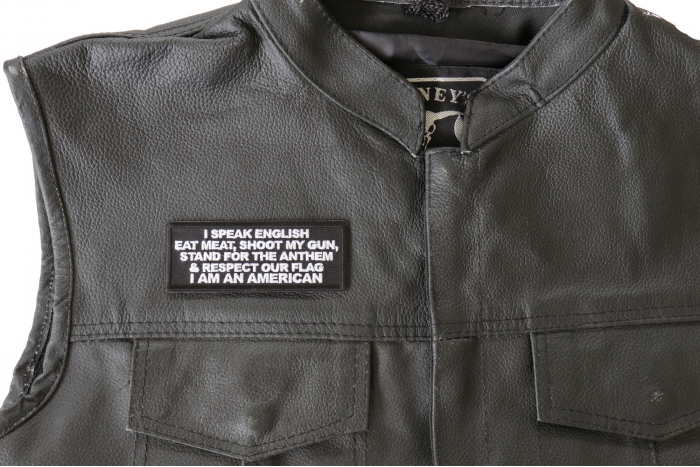 I Speak English Eat Meat Shoot My Gun Patch - 4x1.5 inch. Embroidered Iron on Patch shown on leather vest
