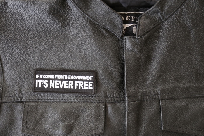 If It Comes from The Government It's Never Free Patch - 4x1.5 inch - Embroidered Iron on Patch shown on leather vest