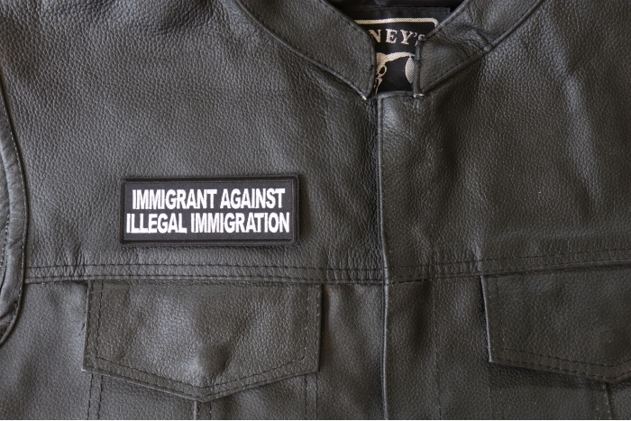 Immigrant Against Illegal Immigration Patch - 4x1.5 inch - Embroidered Iron on Patch shown on leather vest