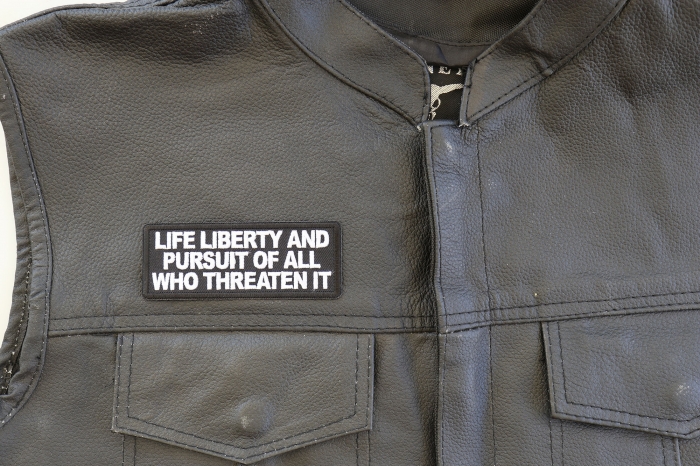 Life Liberty and Pursuit of All Who Threaten it Patch - 4x1.5 inch. Embroidered Iron on Patch shown on leather vest