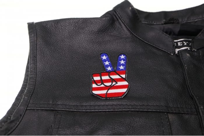Peace Hand Sign with American Flag Patch - 2.1x3.5 inch. Embroidered Iron on Patch shown on leather vest