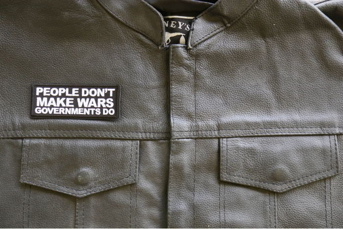 People Don't Make Wars Governments Do Iron on Patch shown on leather vest