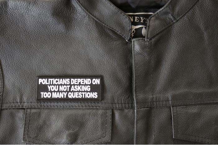 Politicians Depend on you not asking too many questions Patch - 4x1.5 inch - Embroidered Iron on Patch shown on leather vest