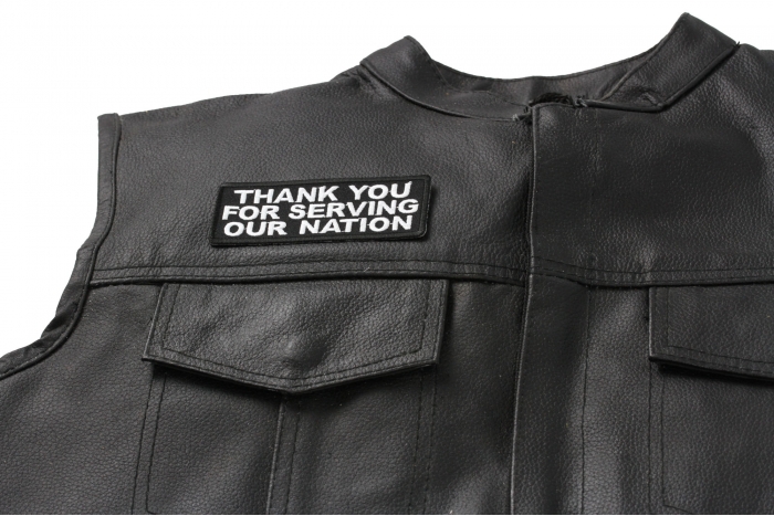 Thank You for Serving Our Nation Patch - 4x1.5 inch. Embroidered Iron on Patch shown on leather vest