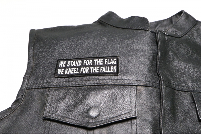 We Stand for the Flag We Kneel for the Fallen Patch, Military Saying Patches shown on leather vest