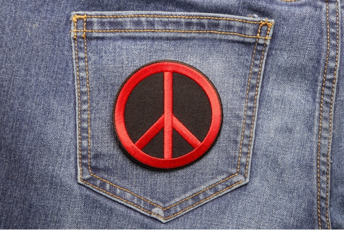 Peace Sign Patch Red On Black shown on jeans