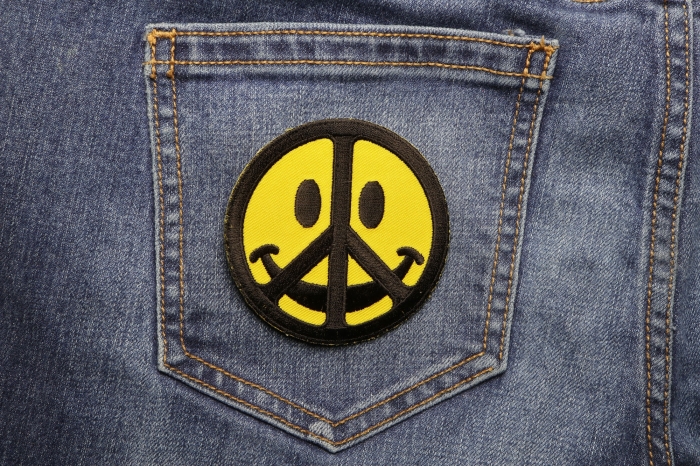 Smiley Face Peace Patch shown on jeans