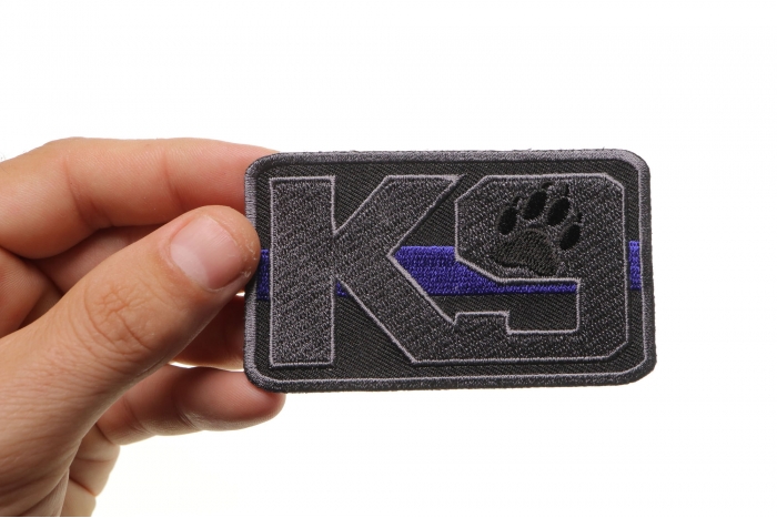 K-9 Thin Blue Line Patch For Law Enforcement shown on hand for size comparison