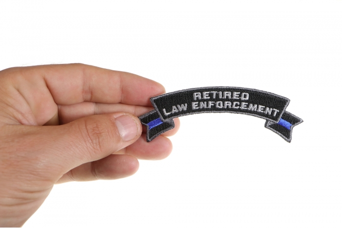 Retired Law Enforcement Rocker Patch shown on hand for size comparison