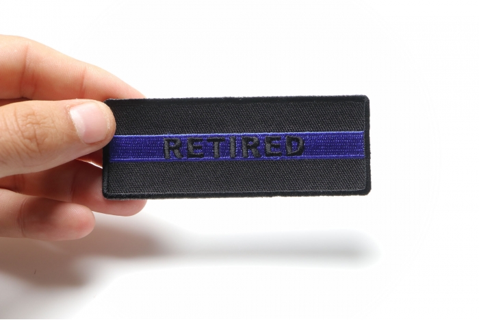 RETIRED Subtle Police Officer Patch shown on hand for size comparison