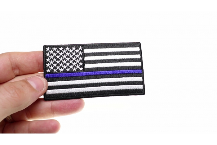 Subdued US Flag With Blue Stripe Patch shown on hand for size comparison