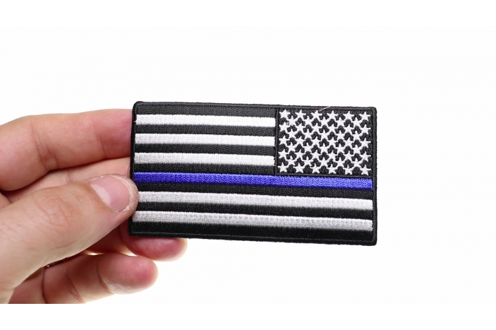 Thin Blue Line American Flag Reversed Patch shown on hand for size comparison