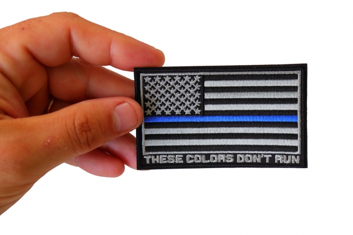 Thin Blue Line American Flag These Colors Don't Run Patch shown on hand for size comparison