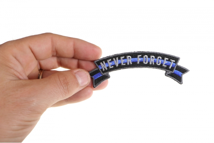 Thin Blue Line Never Forget Rocker Patch shown on hand for size comparison