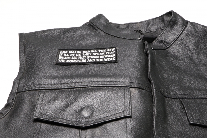 and Maybe Remind The Few if Ill of Us They Speak That We are All That Stands Between The Monsters and The Weak Patch - 4x1.5 inch. Embroidered Iron on Patch shown on leather vest