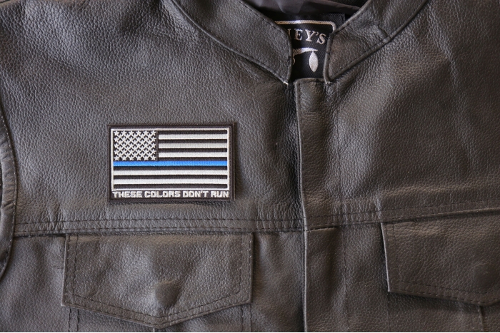 Thin Blue Line American Flag These Colors Don't Run Patch - 3.5x2.1 inch. Embroidered Iron on Patch shown on leather vest