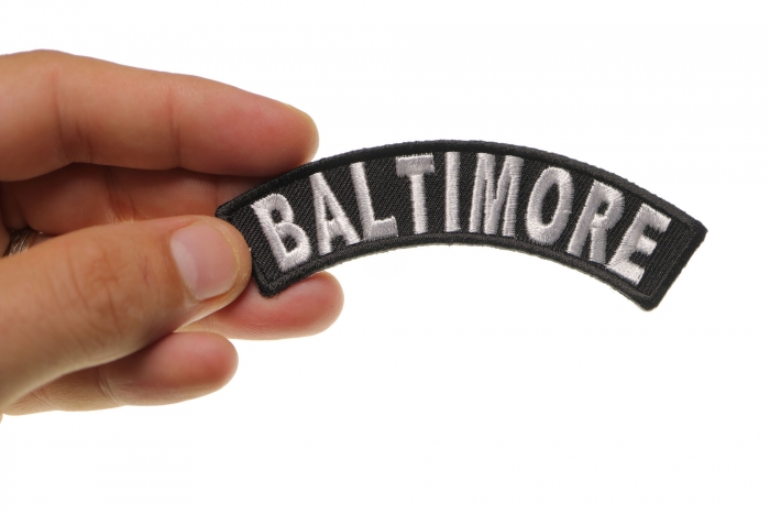 Baltimore Patch shown on hand for size comparison