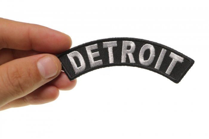 Detroit Patch shown on hand for size comparison