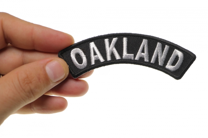 Oakland Patch shown on hand for size comparison