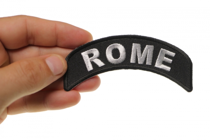 Rome City Patch shown on hand for size comparison