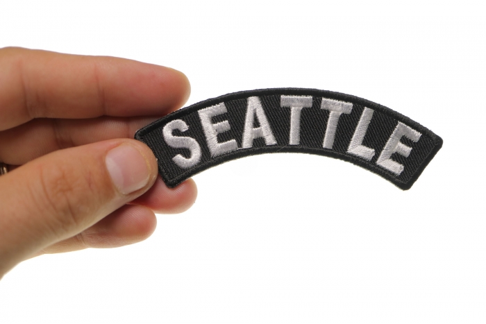 Seattle Patch shown on hand for size comparison