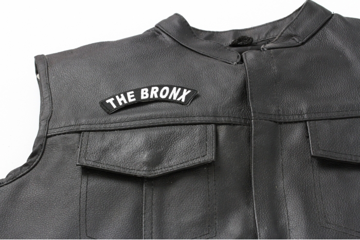 The Bronx Rocker Patch - 4x1.5 inches. Embroidered Iron on Patch shown on leather vest