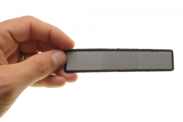 Small Reflective 5 Inch Strip Patch shown on hand for size comparison