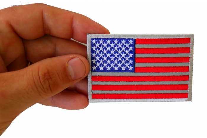American Flag Reflective Patch shown on hand for size comparison