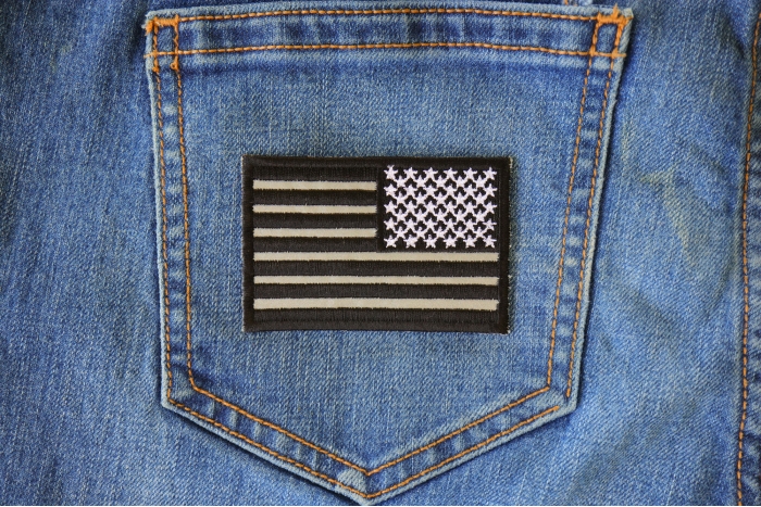Reverse Black Reflective US Flag Patch shown on jeans