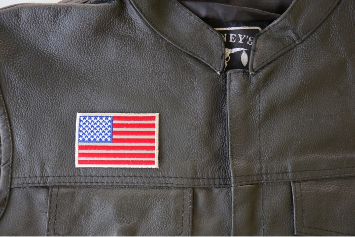 American Flag Reflective Patch - 3x2 inch. Embroidered Iron on Patch shown on leather vest