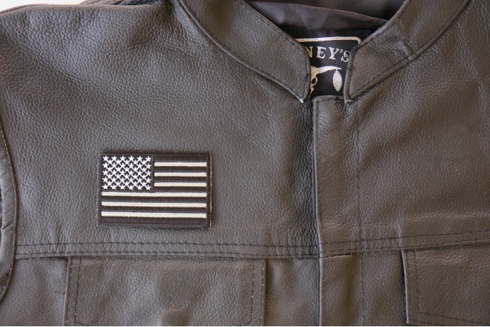 Black White and Reflective US Flag Patch - 3x2 inch. Embroidered Iron on Patch shown on leather vest