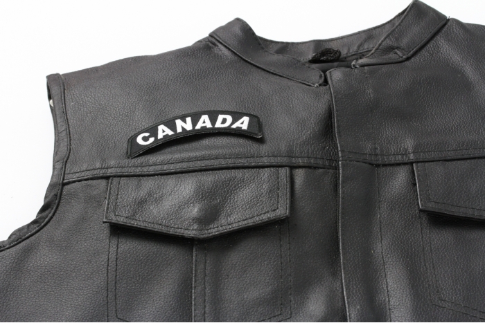 Canada Rocker Patch - 4x1.5 inch. Embroidered Iron on Patch shown on leather vest