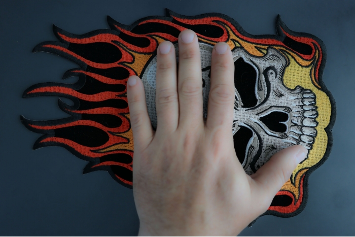 Flaming Tattoo Skull Large Back Patch shown on hand for size comparison