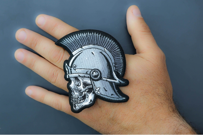 Roman Skull Patch shown on hand for size comparison