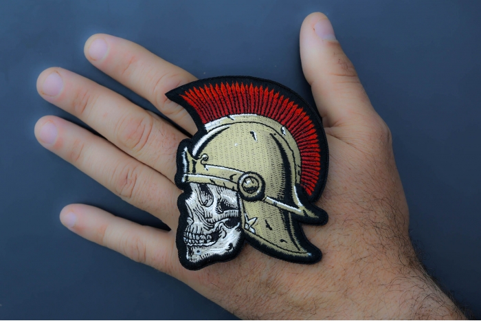 Roman Skull Soldier Patch shown on hand for size comparison