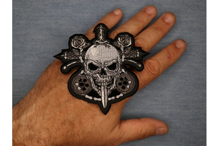 Skull and Roses Patch shown on hand for size comparison