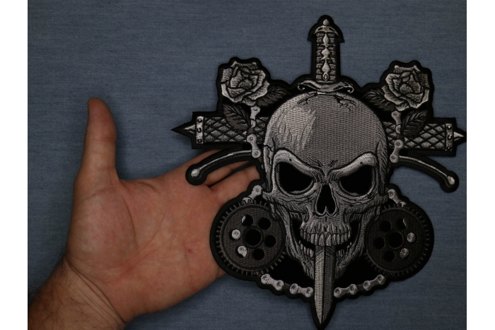 Skull and Roses Patch shown on hand for size comparison