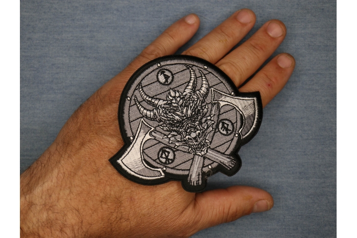 Viking Dragon and Axes Patch shown on hand for size comparison