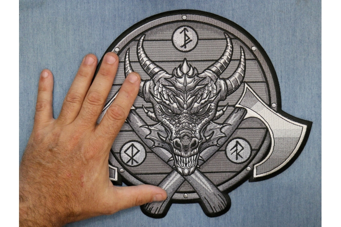 Viking Dragon and Axes Patch shown on hand for size comparison