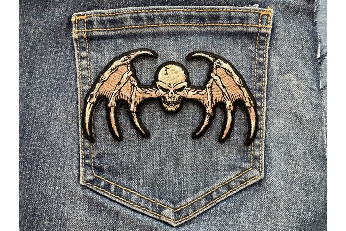 Bat Wings Skull Patch shown on jeans