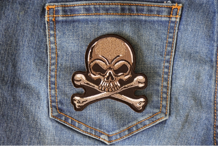 Gray Skull and Cross Bones Patch shown on jeans