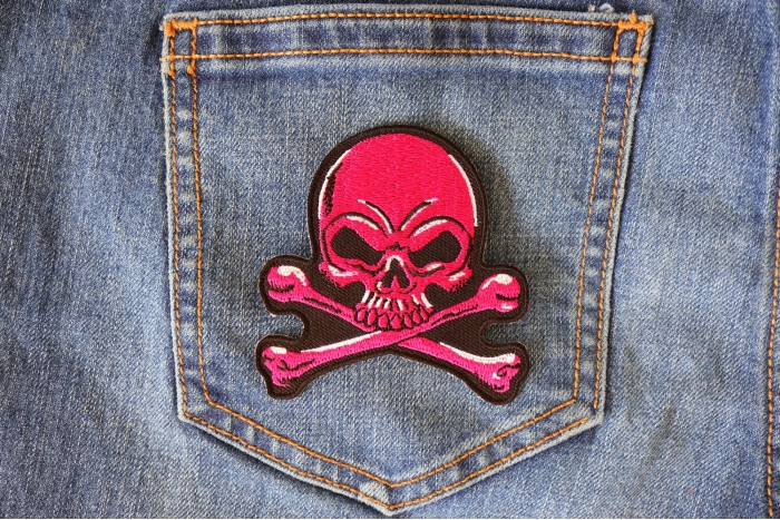 Pink Skull and Cross Bones Patch shown on jeans